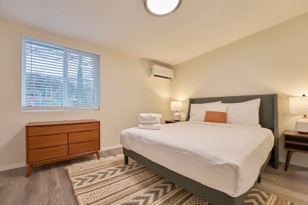 Bedroom with a king bed and warm terracotta accents