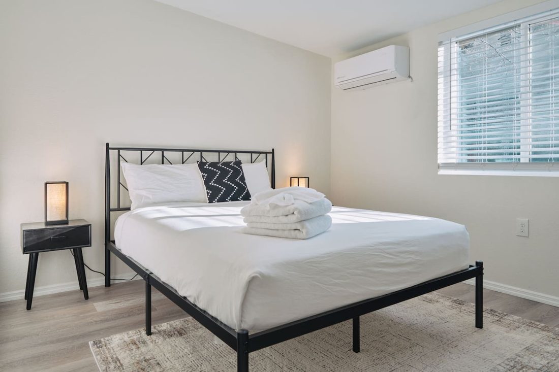 Second bedroom with a queen bed and clean, modern styling