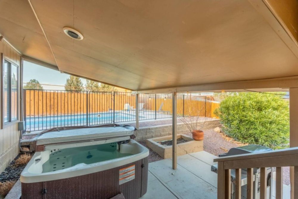 Covered heated hot tub beside the private pool
